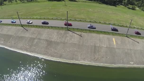 Hermosa carretera con coches y lago. Disparo aéreo — Vídeo de stock