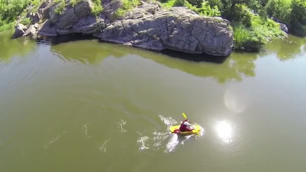 Lateral flight over  person in  kayak on  quiet  river. Aerial top — Stock Video