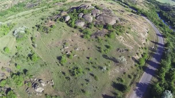 Stone hill and road . Aerial top — Stock Video