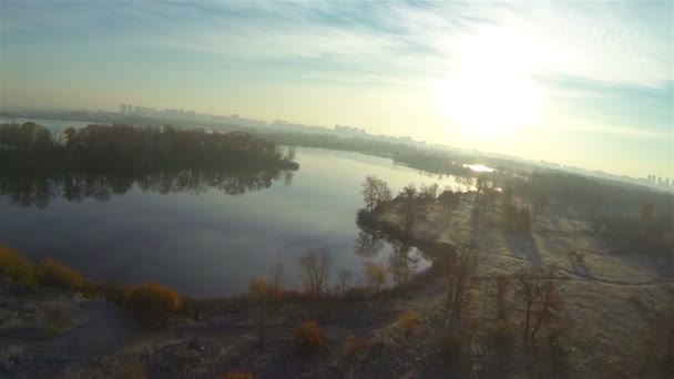 Morning fly like bird  over autumn field  and river at low height. Aerial — Stock Video