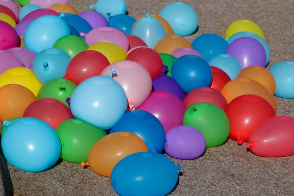 Colorful balloons are filled with water. Prepared for water combat to be thrown. Props for a summer party and children's party. Balloon.