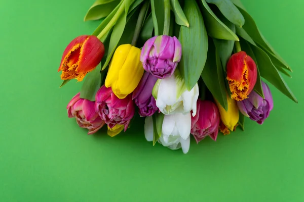 Bouquet of tulips. Flower delivery. Green background . Tulip. Copy space.