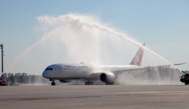 Kyiv, Ukraine - July 1, 2020: Airplane Boeing 787-9 Dreamliner. TC-LLK TURKISH AIRLINES. Runway. Turkish plane. Welcome water rainbow. Arch. Washing the plane from fire trucks.