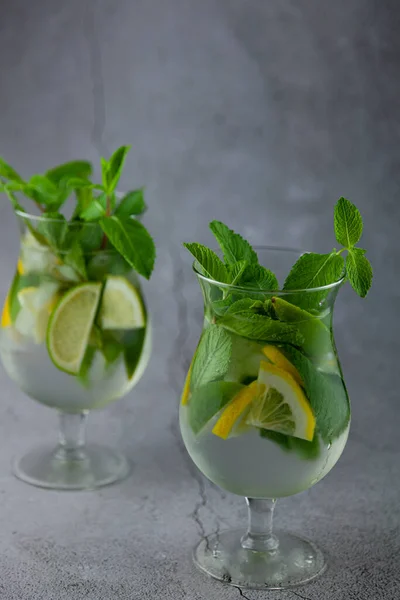 Mojito and Lemonade summer cold drink in a plastic glass with a straw.  Coctail with mint, lemon, lime and ice. Serve at the bar. Beverage closeup  Stock Photo - Alamy