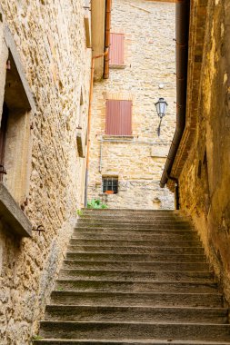 Steps old narrow street in San Marino. Stairs of houses street architecture. Europe travel. Wall