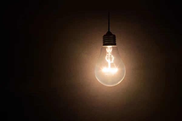 Light bulb on dark background Stock Picture