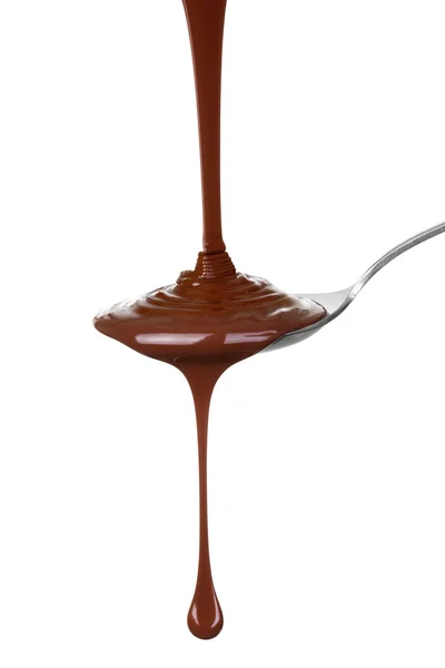 Melted chocolate poured into a spoon. — Stock Photo, Image