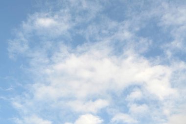 Mavi gökyüzünde güzel bulutlar. Güneş kabarık bulutların arasında parlıyor..