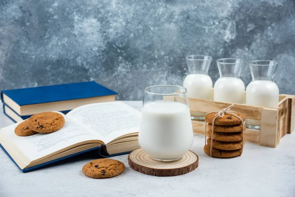 Delicious cookies with glass of milk and book — Stock Photo, Image