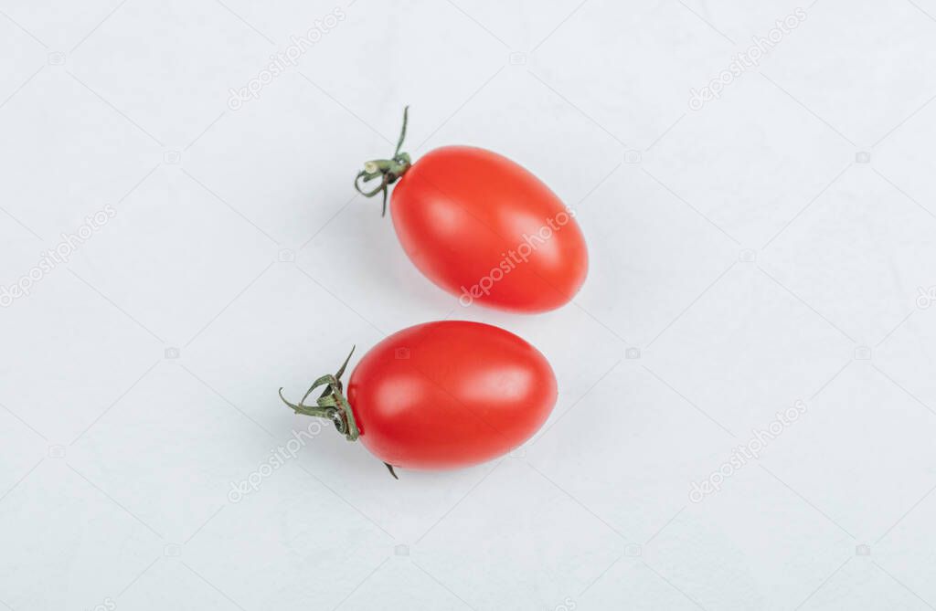 Close up photo of two cherry tomato. on white background