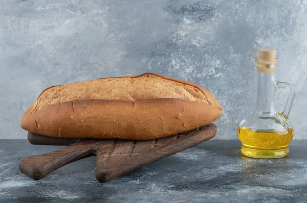 Photo of White bread with oil on the wooden board — Stock Photo, Image