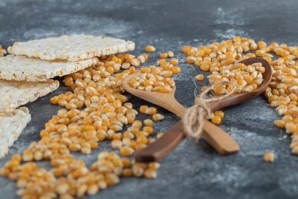 Drewniane łyżki słodkich kukurydzy z chrupiącym chlebem ryżowym — Zdjęcie stockowe
