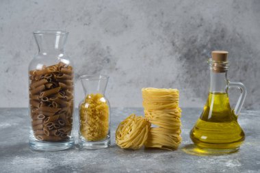 Bir şişe yağlı farklı bir çiğ makarna.
