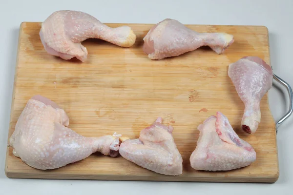 Raw chicken meat parts on wooden chopping board — Stock Photo, Image