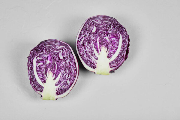Fresh purple half sliced cabbage isolated on white background