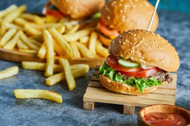 Tahtada patates kızartmalı çizburger.