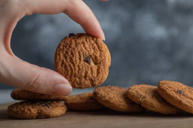Gri arka planda çikolatalı lezzetli kurabiyeler.