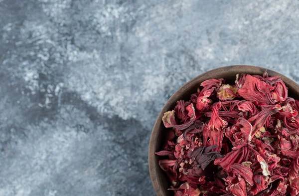 Dry hibiscus tea in wooden bowl. High quality photo