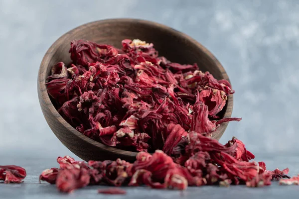 Dry hibiscus tea in wooden bowl. High quality photo