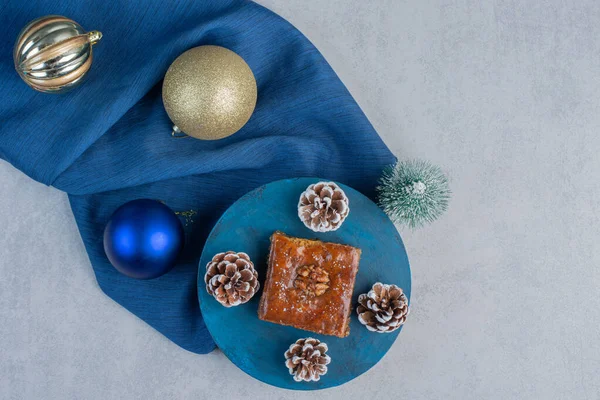 Bakhlava Two Pine Cones Blue Board Amidst Bundle Christmas Decorations — Stock Photo, Image