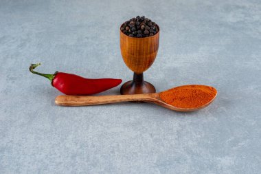 Kırmızı biber, harmanlanmış toz ve mavi arka planda siyah tanecikler. Yüksek kalite fotoğraf