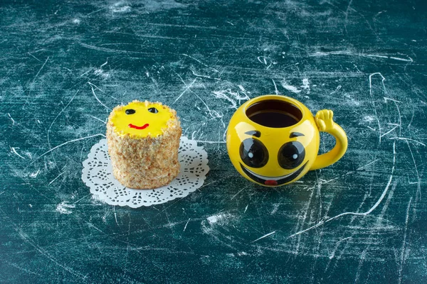A delicious cake with yellow cup of tea. High quality photo