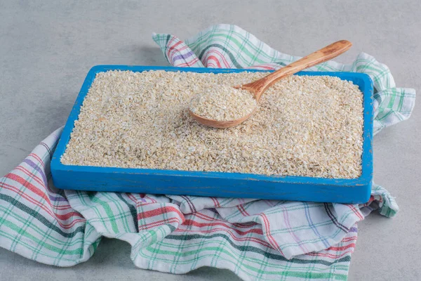 A large tray of short grain rice on a towel on marble background. High quality photo