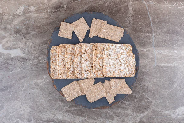 Crispbread and puffed rice cakes in tray , on the marble background. High quality photo