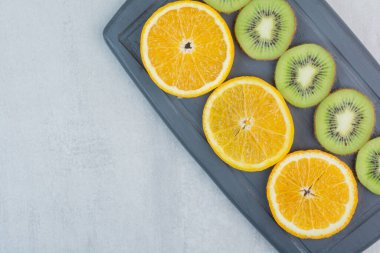 Koyu tabakta portakal ve kivi dilimleri. Yüksek kalite fotoğraf