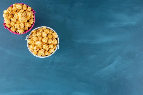 Two Buckets Filled Caramel Coated Popcorn Blue Background High Quality — Stock Photo, Image