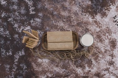 Tahta tabakta atıştırmalıklar ve krakerler, bir bardak süt, üst manzara. Yüksek kalite fotoğraf
