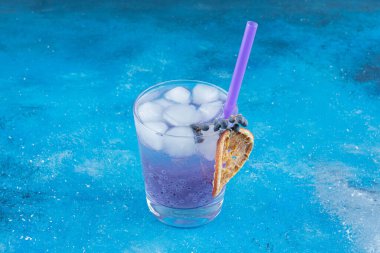 Mavi arka planda işlenmiş bir bardak meyve suyu. Yüksek kalite fotoğraf