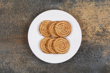 Beyaz tabakta lezzetli susamlı bisküviler. Yüksek kalite fotoğraf