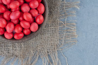 Kırmızı şekerler mermer arka plandaki trivet bardağında. Yüksek kalite fotoğraf