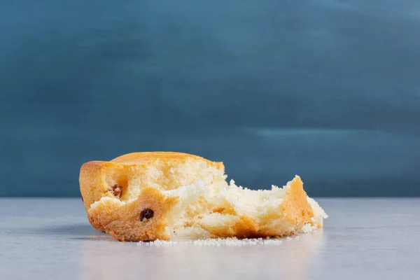 Crumbly cake torn apart on marble background. High quality photo