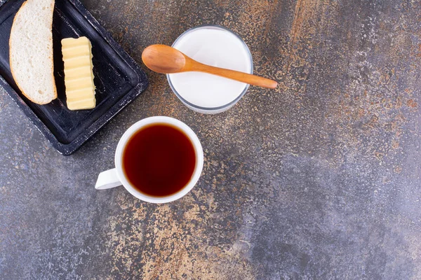 Breakfast board with bread and a cup of tea. High quality photo