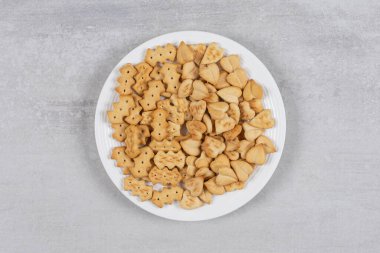 Beyaz tabakta tuzlanmış kraker yığını. Yüksek kalite fotoğraf