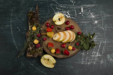 Tahta nesneler üzerindeki taze meyveler izole edilmiş mermer arka plan