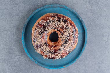 Gri arkaplanda mavi bir tabak tatlı çörek. Kaliteli bir fotoğraf.