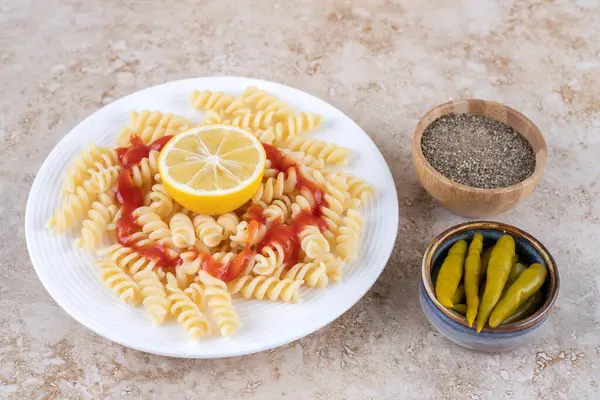 Een Bord Macaroni Met Kleine Schaaltjes Zwarte Peper Pepers Marmeren — Stockfoto