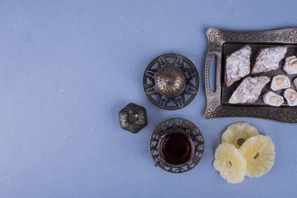 Μεταλλική Πιατέλα Ζαχαροπλαστικής Απολαύσεις Και Ένα Ποτήρι Τσάι Υψηλής Ποιότητας — Φωτογραφία Αρχείου