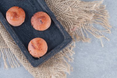 Siyah ahşap tabakta sıcak kızarmış sosis dilimleri. Yüksek kalite fotoğraf