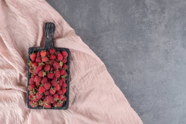 Siyah tabakta lezzetli kırmızı ahududular. Yüksek kalite fotoğraf