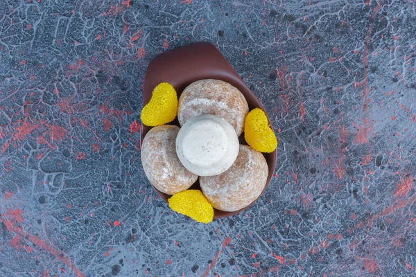 Vanilla powder coated cookies and marmalades in a small bowl on abstract background. High quality photo