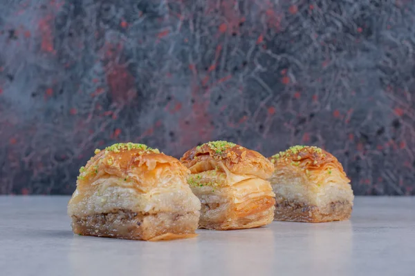 Sweet baklava with pistachios on marble background. High quality photo