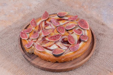 İncirli ve ahşap tabakta şerbetli vanilyalı turta. Yüksek kalite fotoğraf