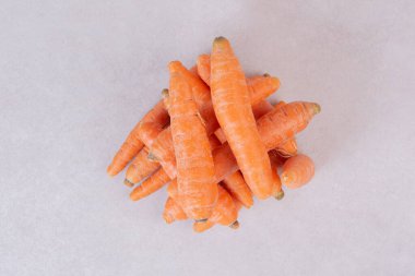 Beyaz arka planda bir sürü taze havuç.