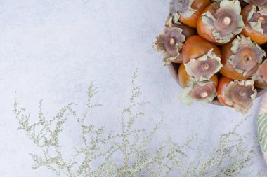 Sarı hurma erikleri gri arka planda ahşap bir tabakta. Yüksek kalite fotoğraf