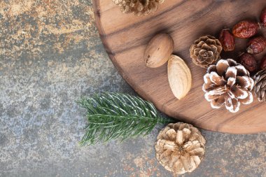 Fındıklı kozalaklar ve ahşap tabakta kurutulmuş meyveler. Yüksek kalite fotoğraf
