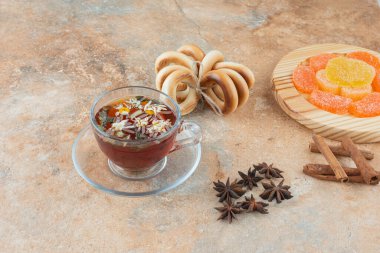 Bitki çayı ve marmelatlı tatlı yuvarlak kurabiyeler.